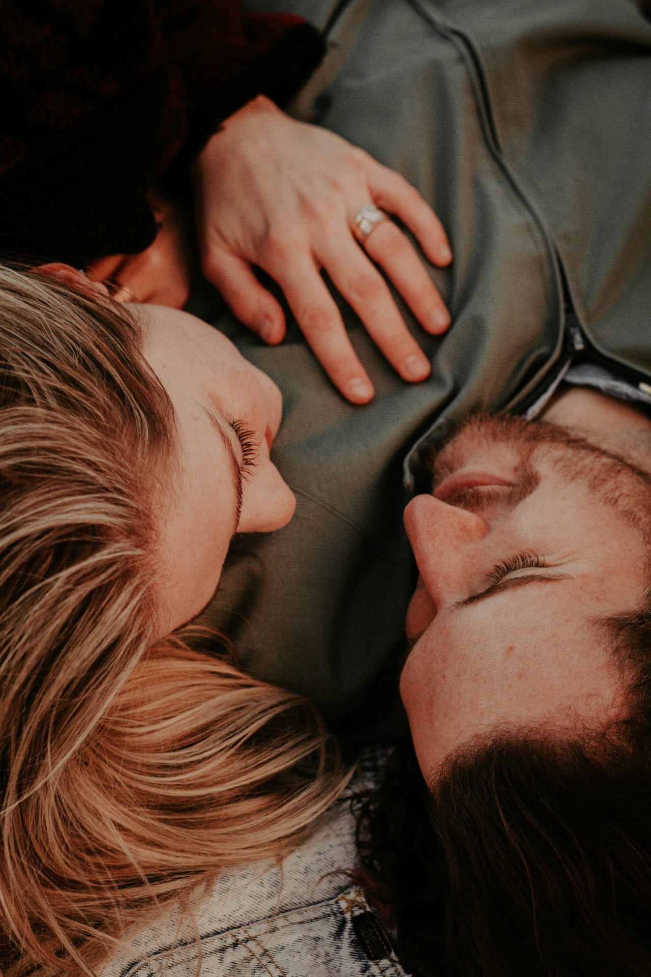 Couple lying close together, sharing a quiet, intimate moment